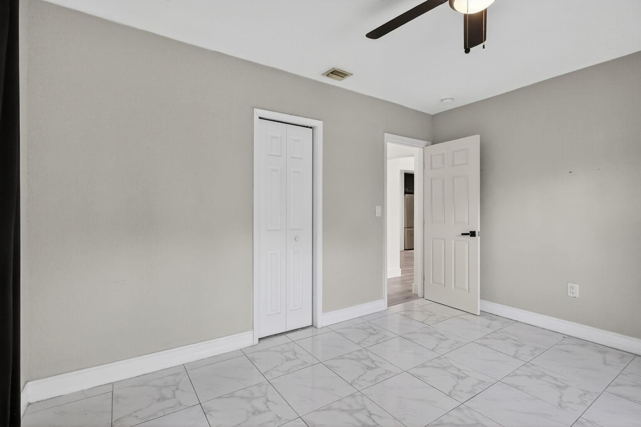 40 Northwest 68th Street Miami, FL 33150 - Photo 10 of 27 an empty room with windows and fan