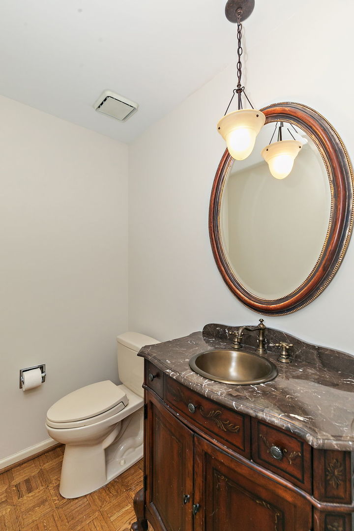 43 North Ravenscraig Lane Inverness, IL 60067 - Photo 14 of 64 a bathroom with a granite countertop toilet a sink and mirror
