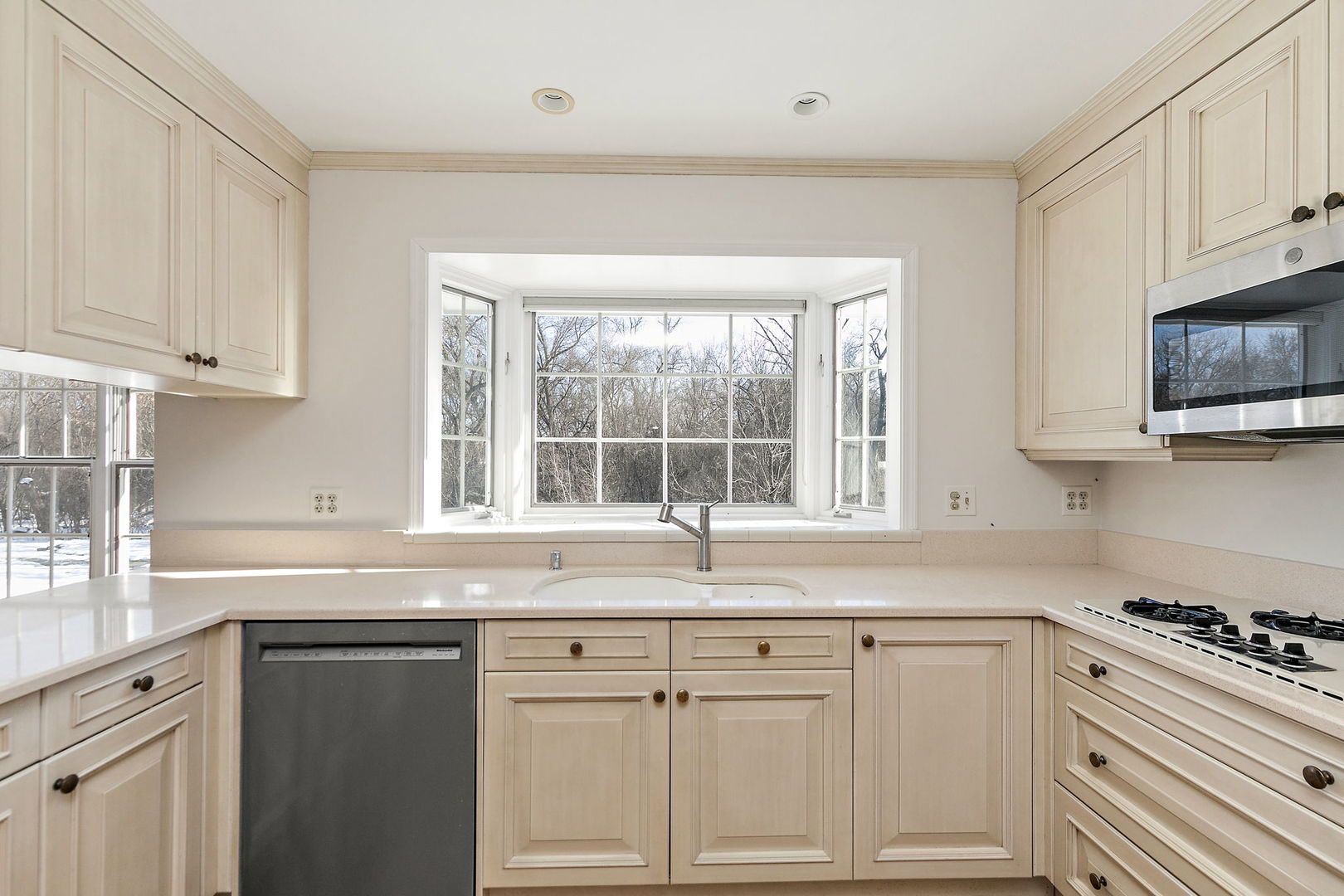43 North Ravenscraig Lane Inverness, IL 60067 - Photo 9 of 64 a kitchen with granite countertop white cabinets and a window