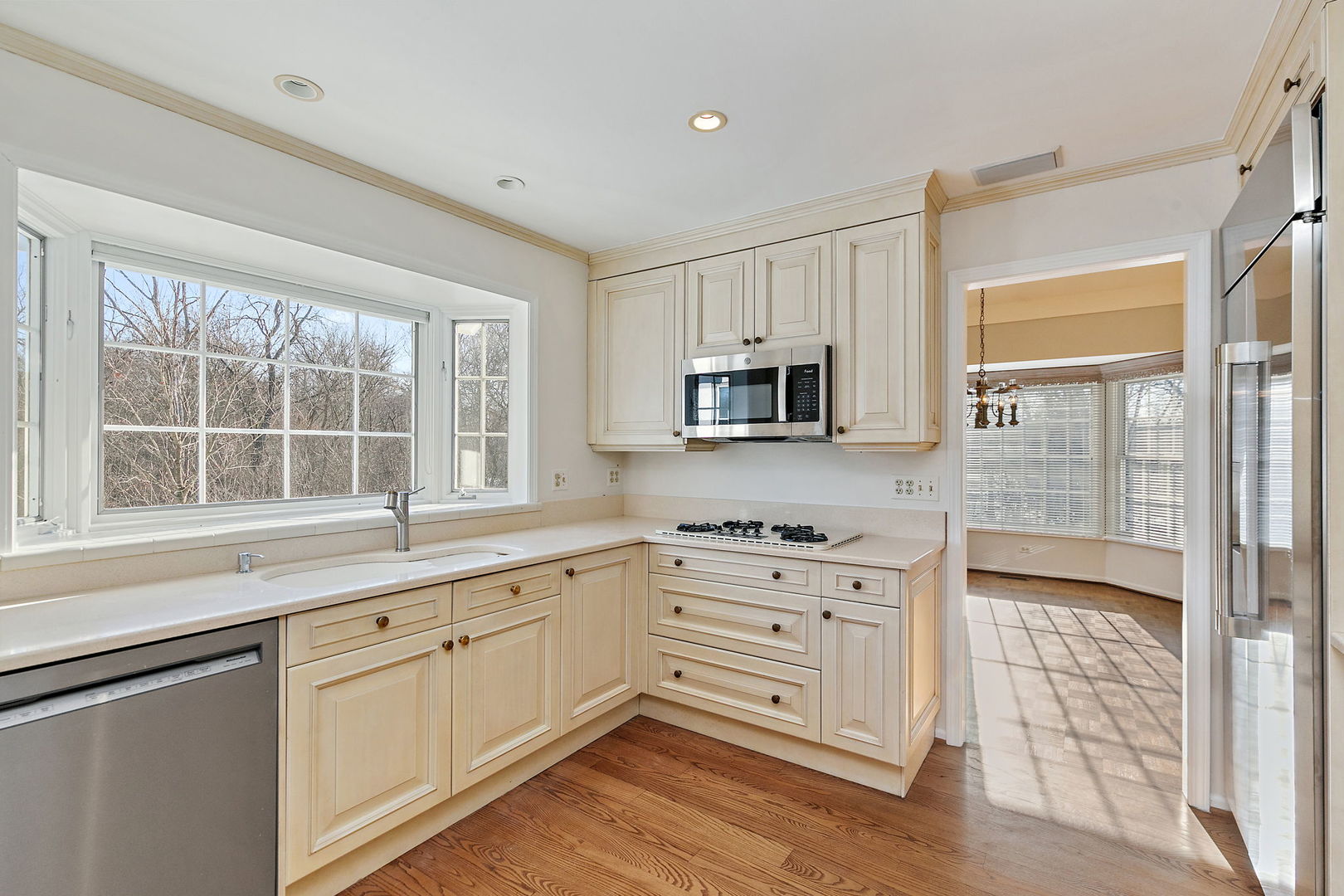 43 North Ravenscraig Lane Inverness, IL 60067 - Photo 10 of 64 a kitchen with stainless steel appliances granite countertop a stove a sink and white cabinets