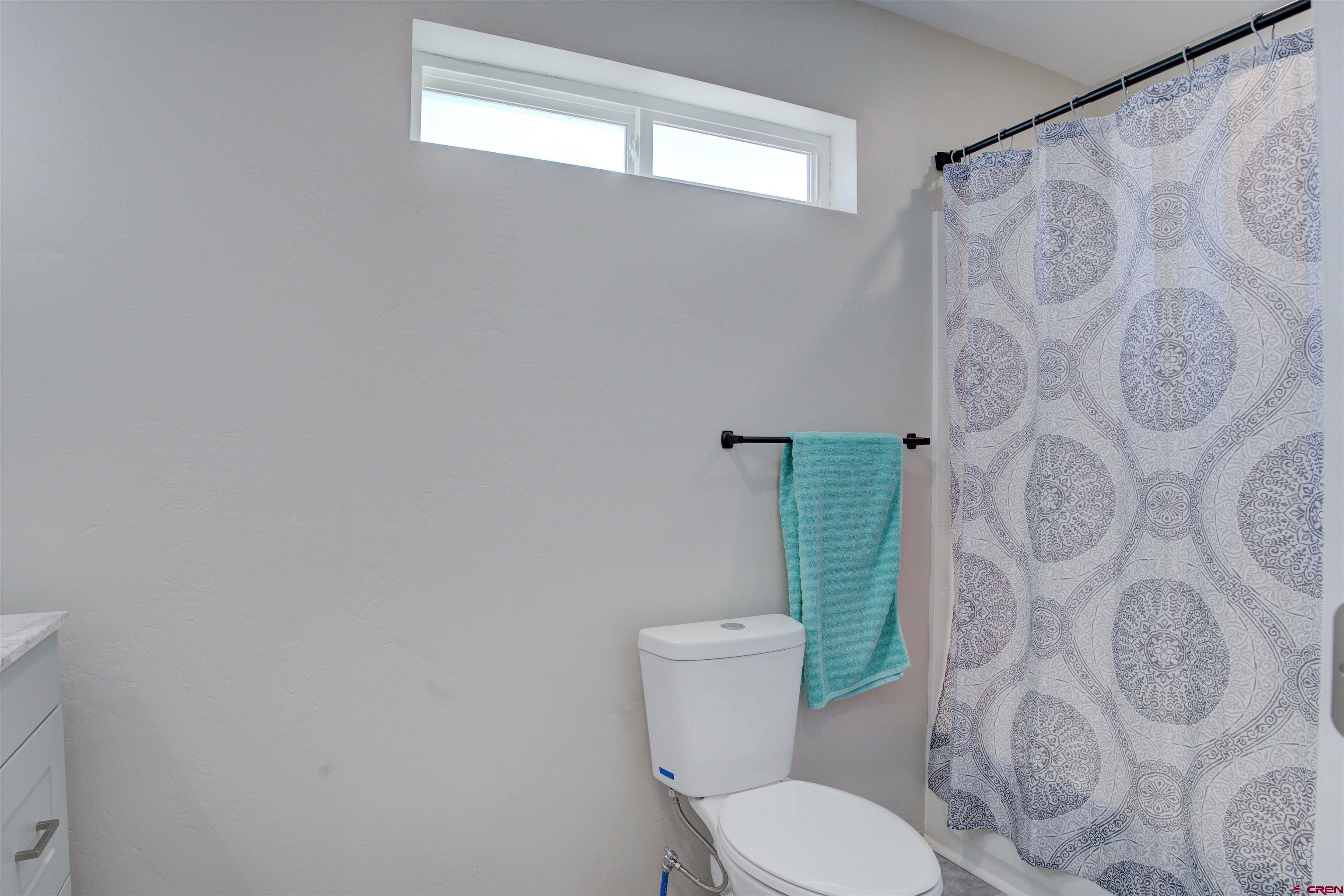 13205 Road 17.9 Loop Cortez, CO 81321 - Photo 28 of 35 a white toilet sitting next to a shower curtain