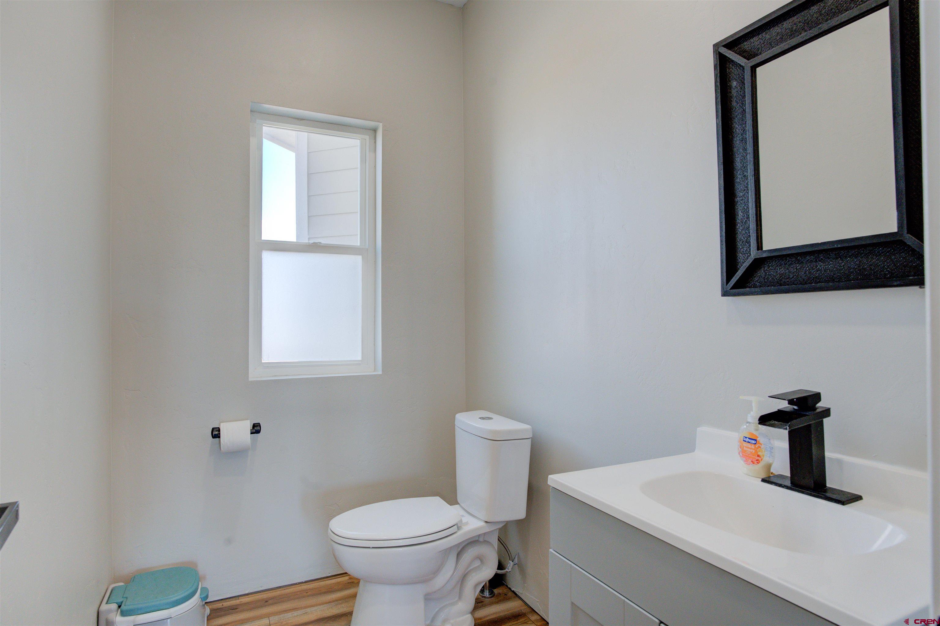 13205 Road 17.9 Loop Cortez, CO 81321 - Photo 29 of 35 a bathroom with a toilet sink and mirror