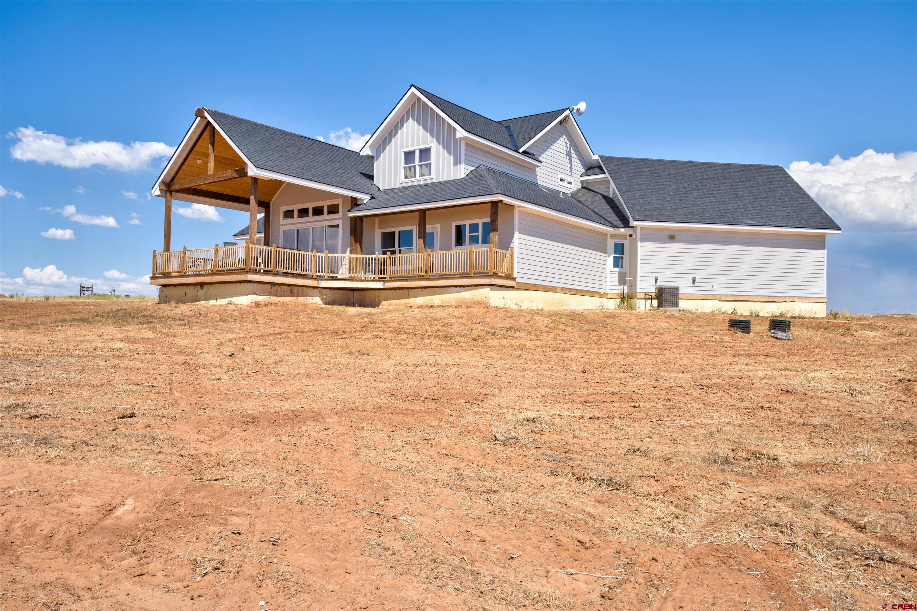 13205 Road 17.9 Loop Cortez, CO 81321 - Photo 5 of 35 a front view of a house with a yard