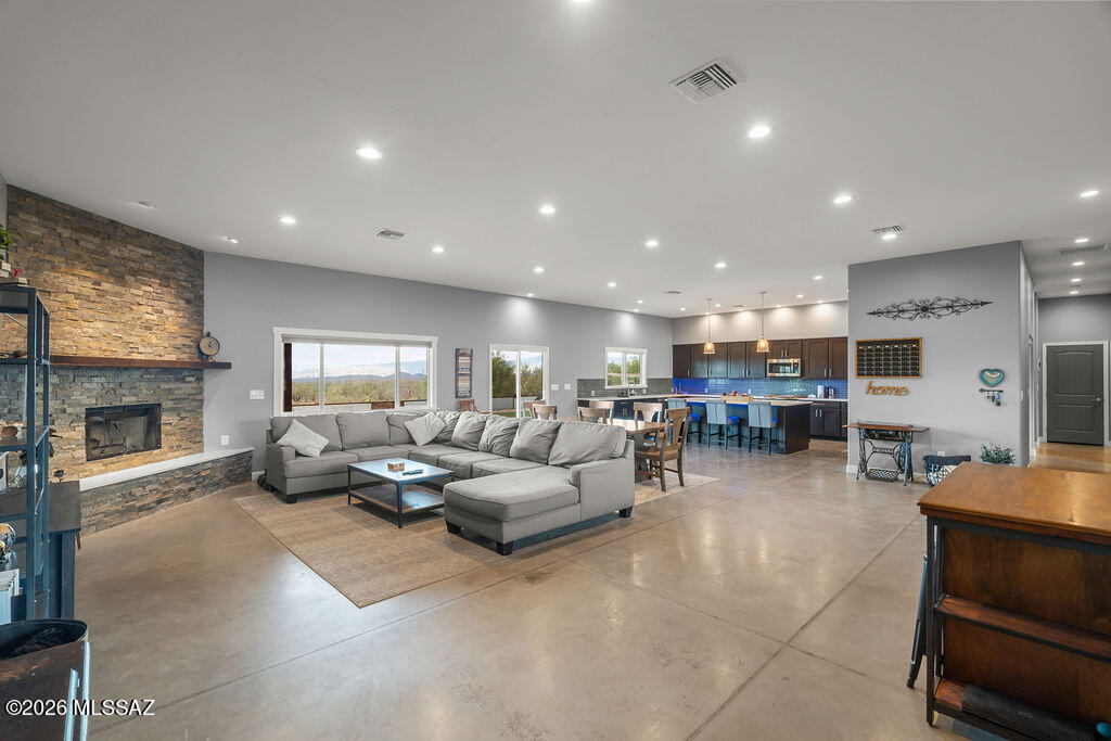 16276 East Empire View Road Vail, AZ 85641 - Photo 12 of 51 a living room with furniture kitchen view and a fireplace