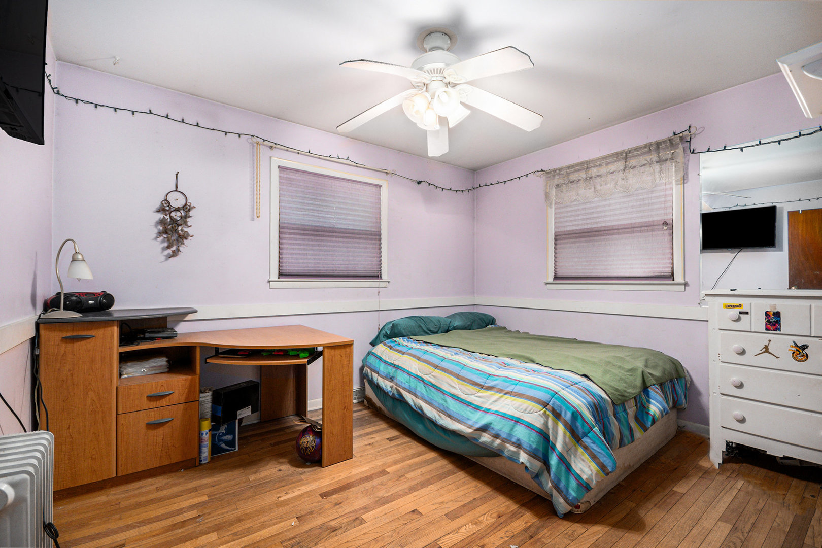 13090 River Road Plano, IL 60545 - Photo 11 of 27 a bedroom with a bed and a flat tv screen on dresser