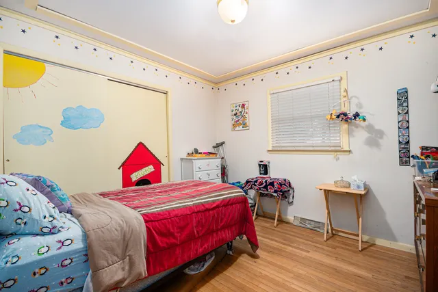 a bedroom with a bed and a dresser