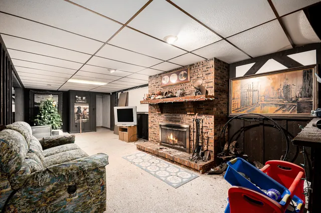 a living room with furniture a flat screen tv and a fireplace