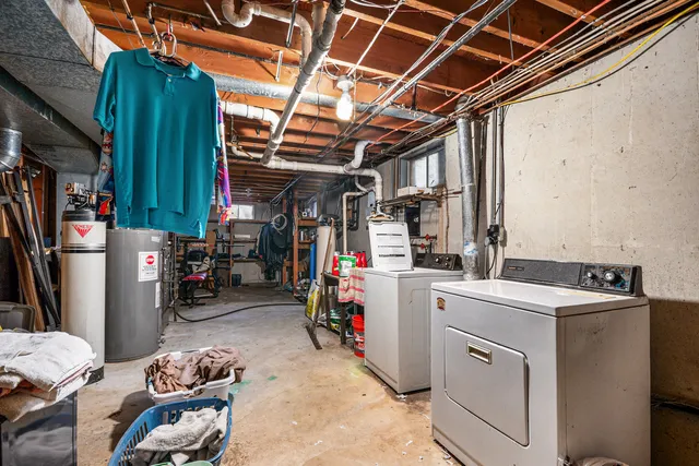 a view of storage and utility room with closet dryer and washer