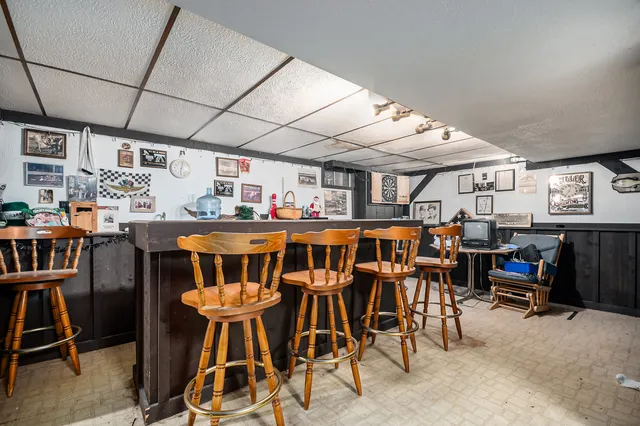 a view of a dining room with furniture and a kitchen view