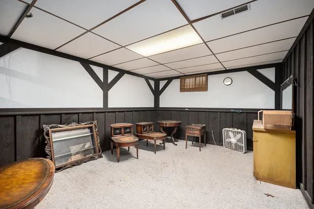 a living room with furniture a window and chairs