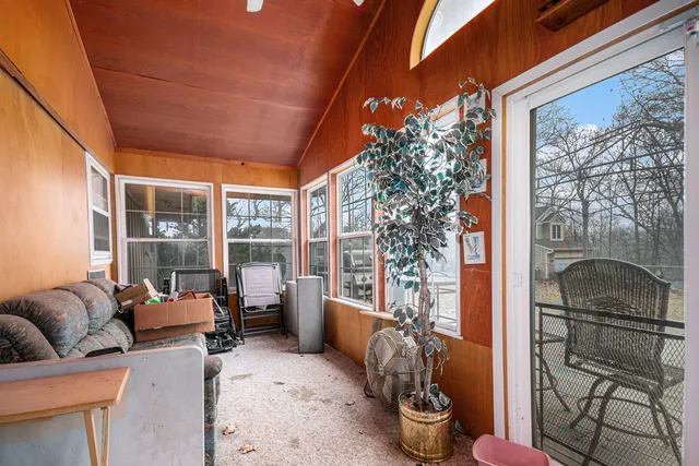 a view of a dinning table and chairs in the patio of the house