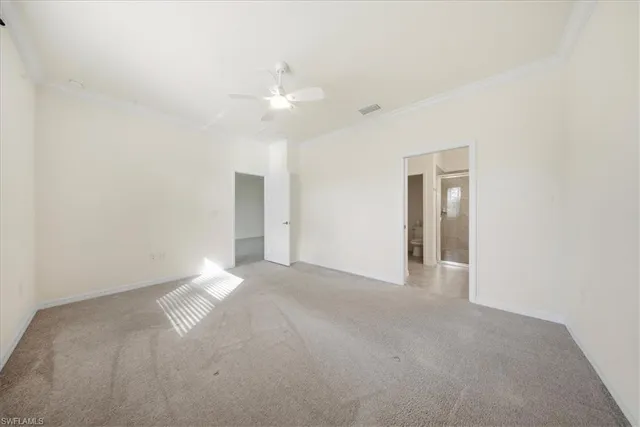 a view of an empty room with a ceiling fan
