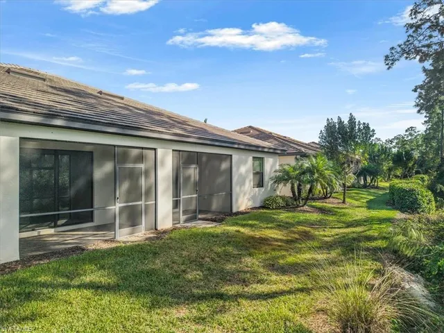 a view of a house with backyard and porch