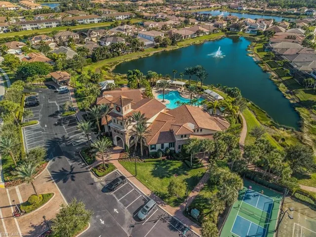 an aerial view of residential houses with outdoor space and lake view