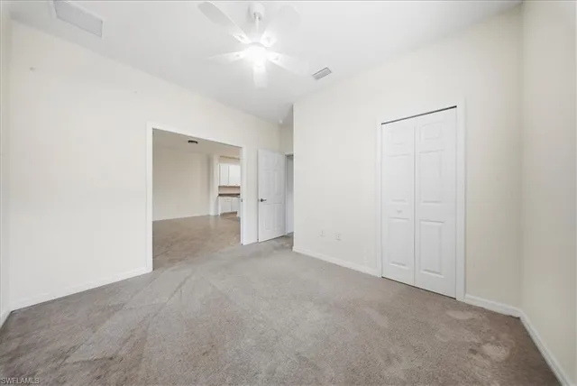 a view of empty room with a fan