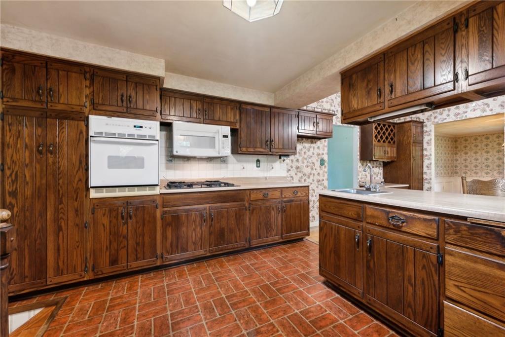 2213 Hall Drive Export, PA 15632 - Photo 11 of 36 a kitchen with stainless steel appliances granite countertop a sink stove and cabinets