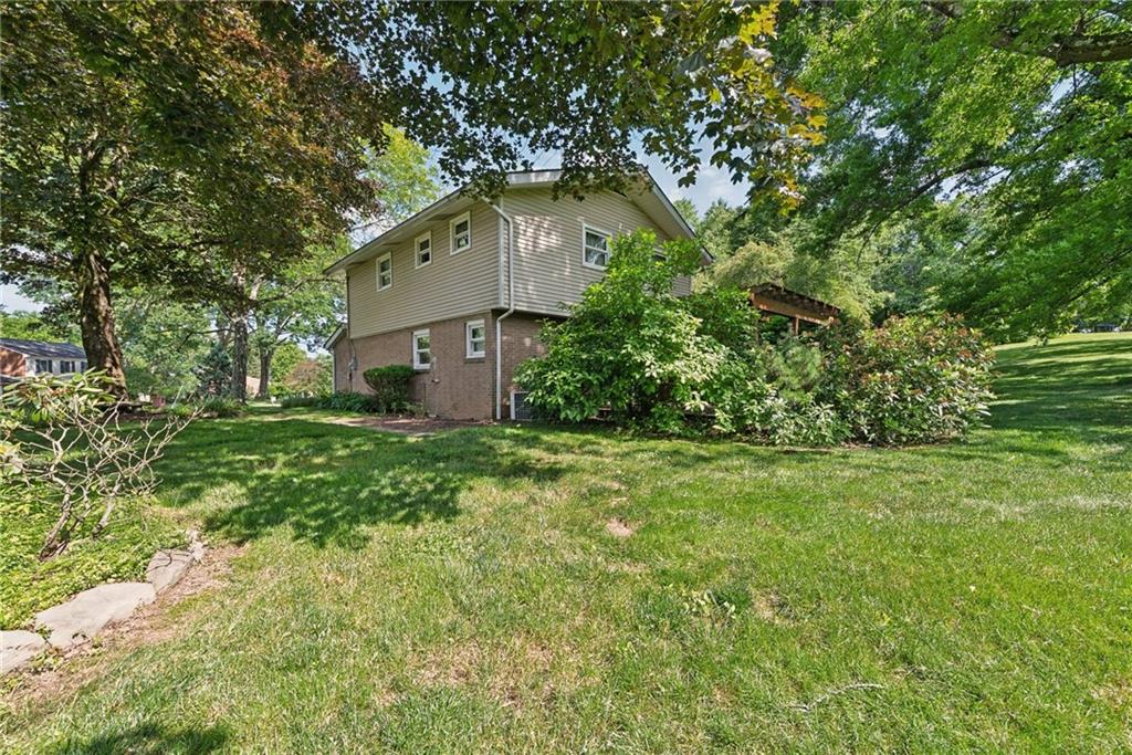 2213 Hall Drive Export, PA 15632 - Photo 34 of 36 a backyard of a house with plants and large trees