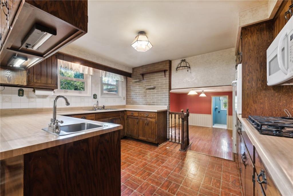 2213 Hall Drive Export, PA 15632 - Photo 9 of 36 a kitchen with stainless steel appliances granite countertop a sink stove and cabinets