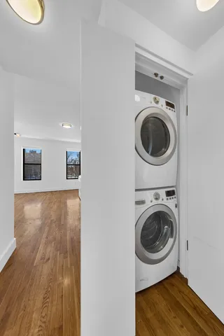 a living room with furniture a lamp and a large window