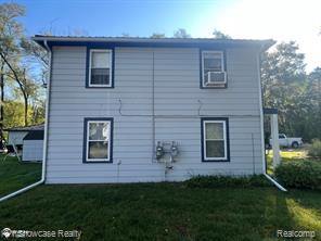 2396 South Long Lake Road Fenton, MI 48430 - Photo 3 of 30 Back of house with a lawn