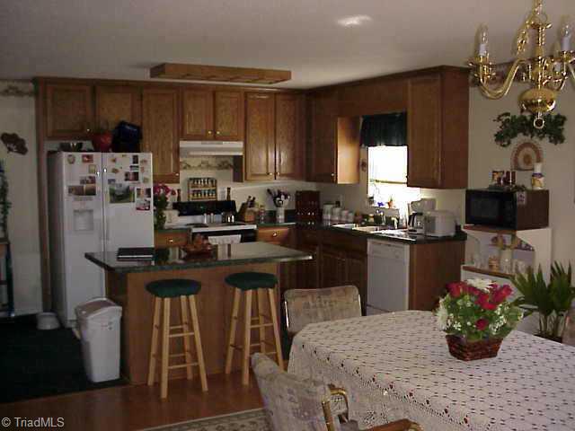209 Whispering Creek Road King, NC 27021 - Photo 8 of 9 Other. Enjoy dinner sitting at the kitchen island.