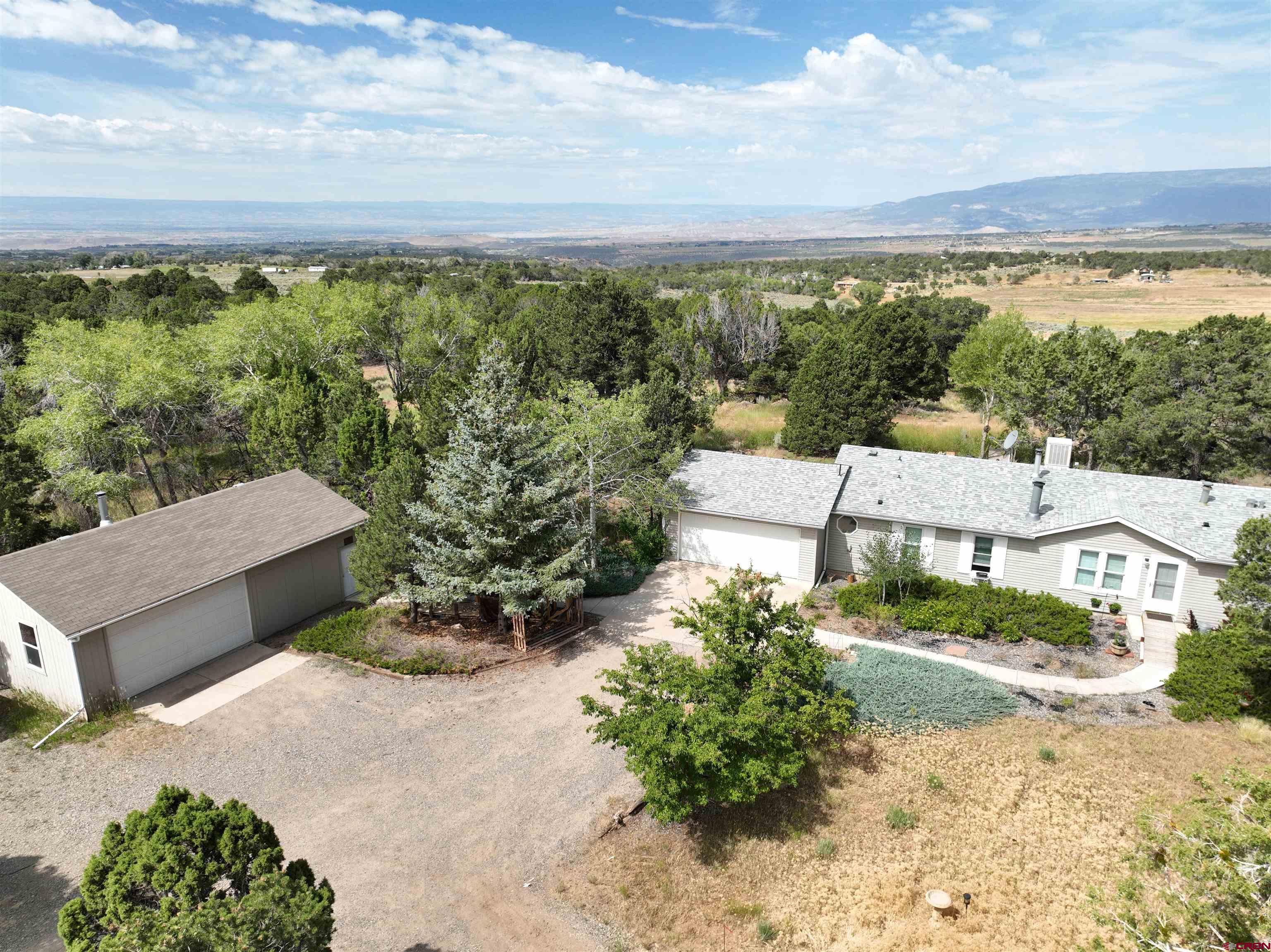 an aerial view of a house with a yard