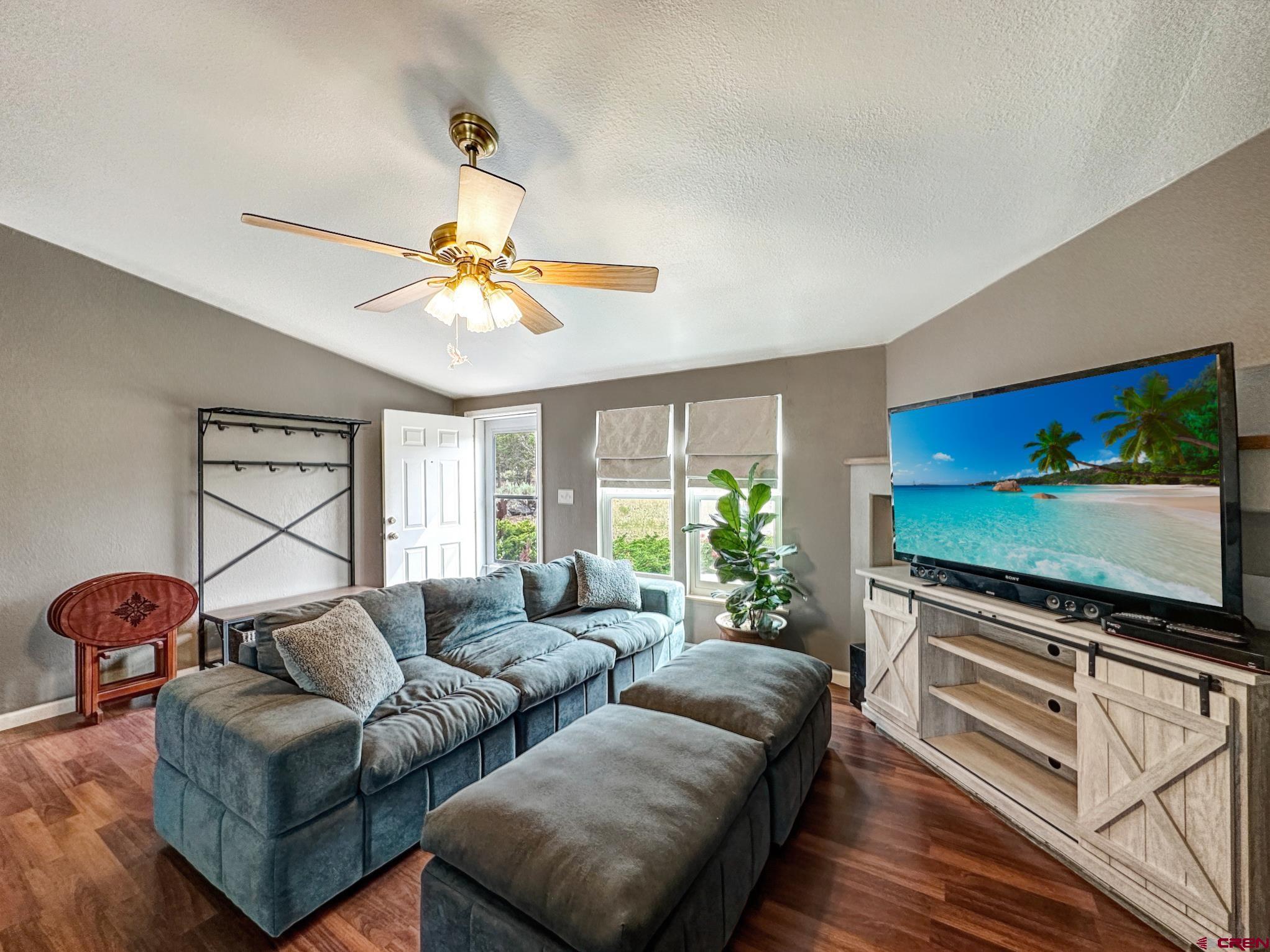 29501 P50 Road Hotchkiss, CO 81419 - Photo 11 of 45 a living room with furniture and a flat screen tv