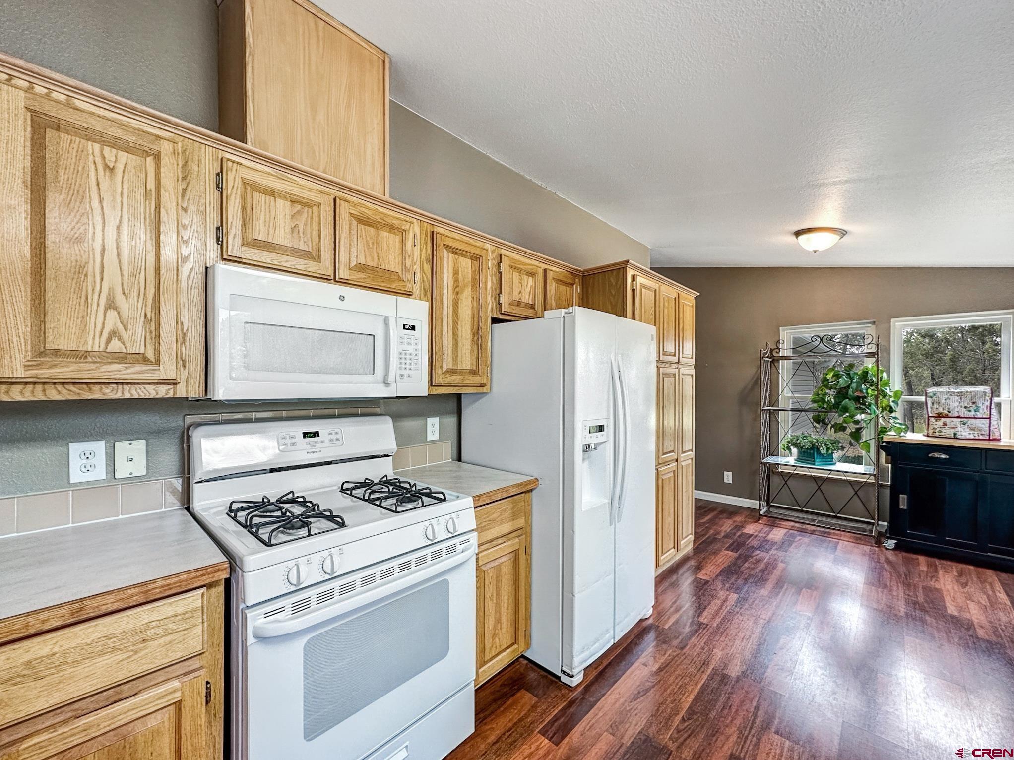 29501 P50 Road Hotchkiss, CO 81419 - Photo 14 of 45 a kitchen with stainless steel appliances granite countertop a refrigerator stove and sink