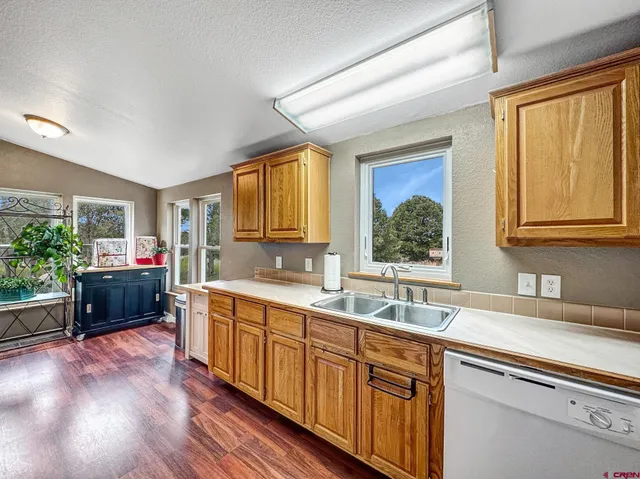 a kitchen that has a sink and a stove in it
