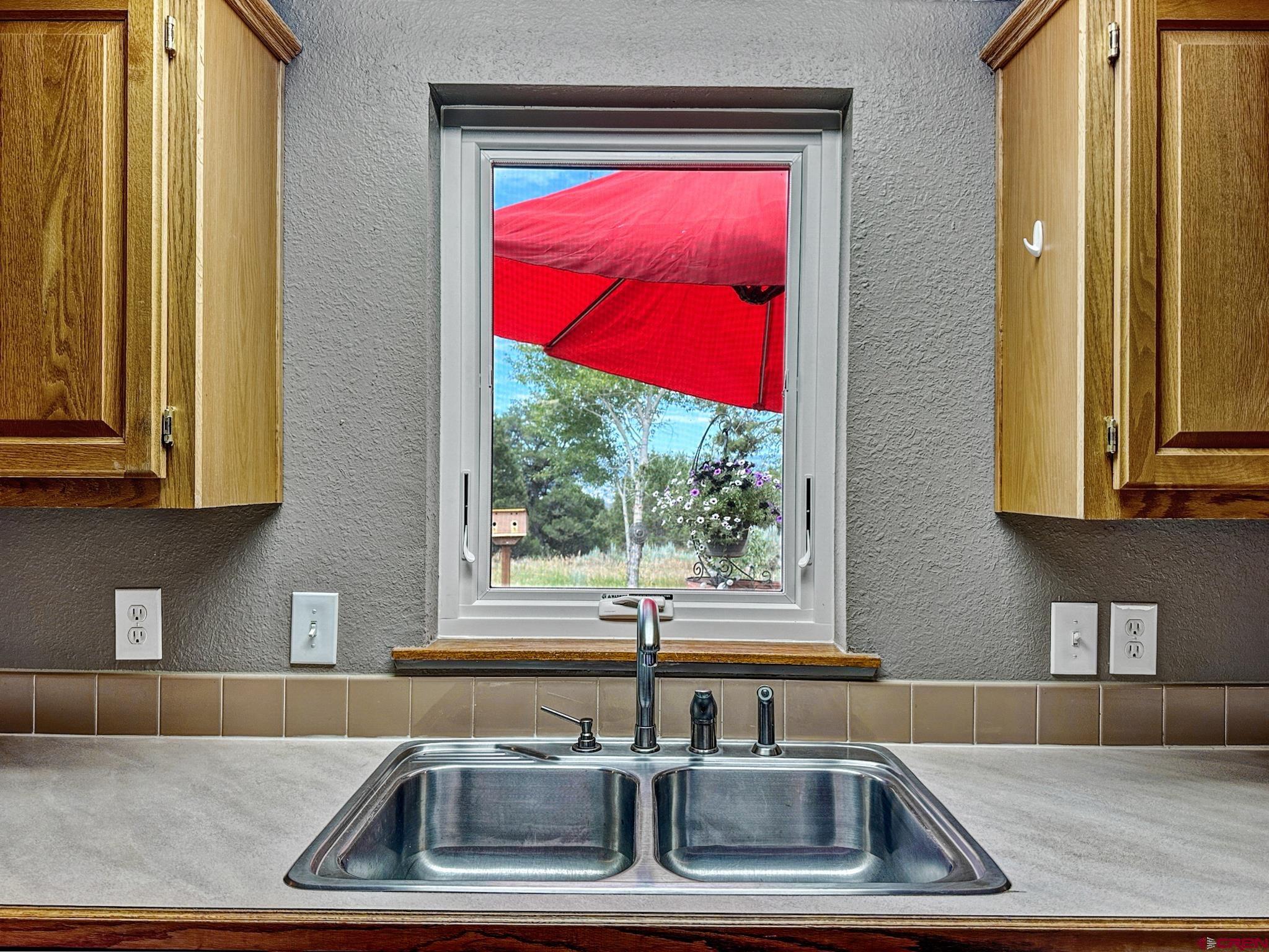 29501 P50 Road Hotchkiss, CO 81419 - Photo 18 of 45 a kitchen that has a sink and a large window