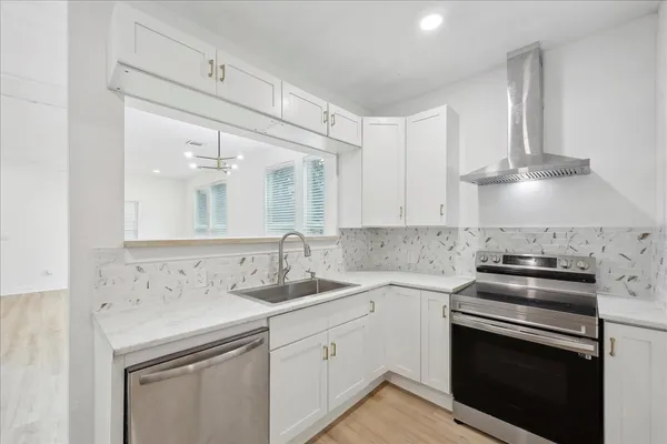a kitchen with a sink stove and cabinets