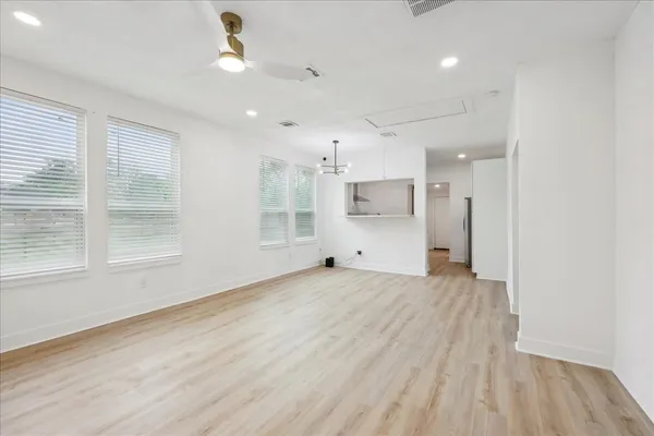 a view of a livingroom with wooden floor and a large window