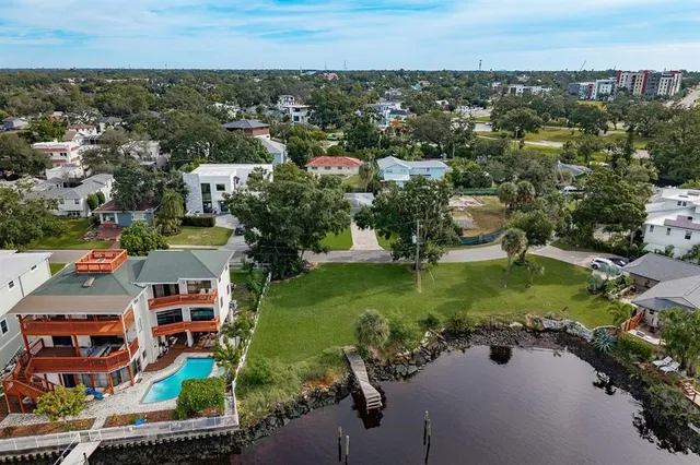 an aerial view of residential houses with outdoor space and river