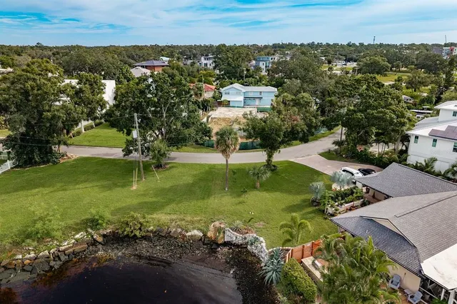 an aerial view of residential houses with outdoor space and parking