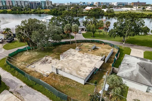 an aerial view of residential houses with outdoor space and swimming pool