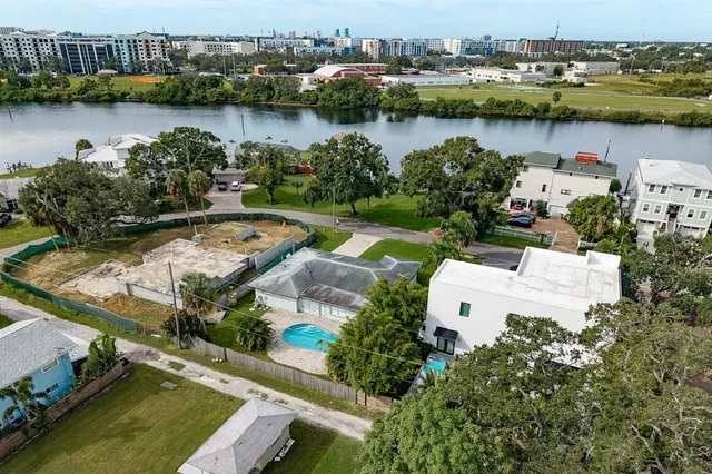 an aerial view of a house with a yard basket ball court and outdoor seating