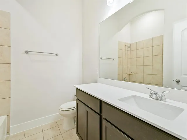 a bathroom with a sink a toilet and a mirror