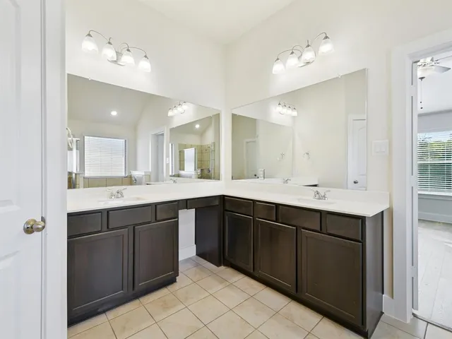a spacious bathroom with a double vanity sink mirror and
