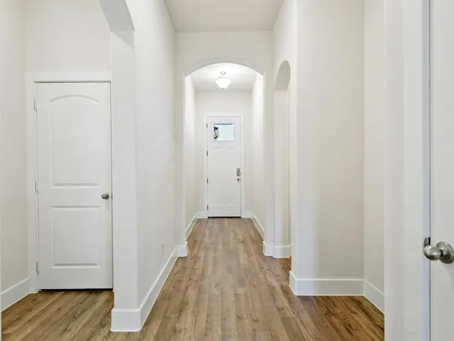 a view of hallway with wooden floor
