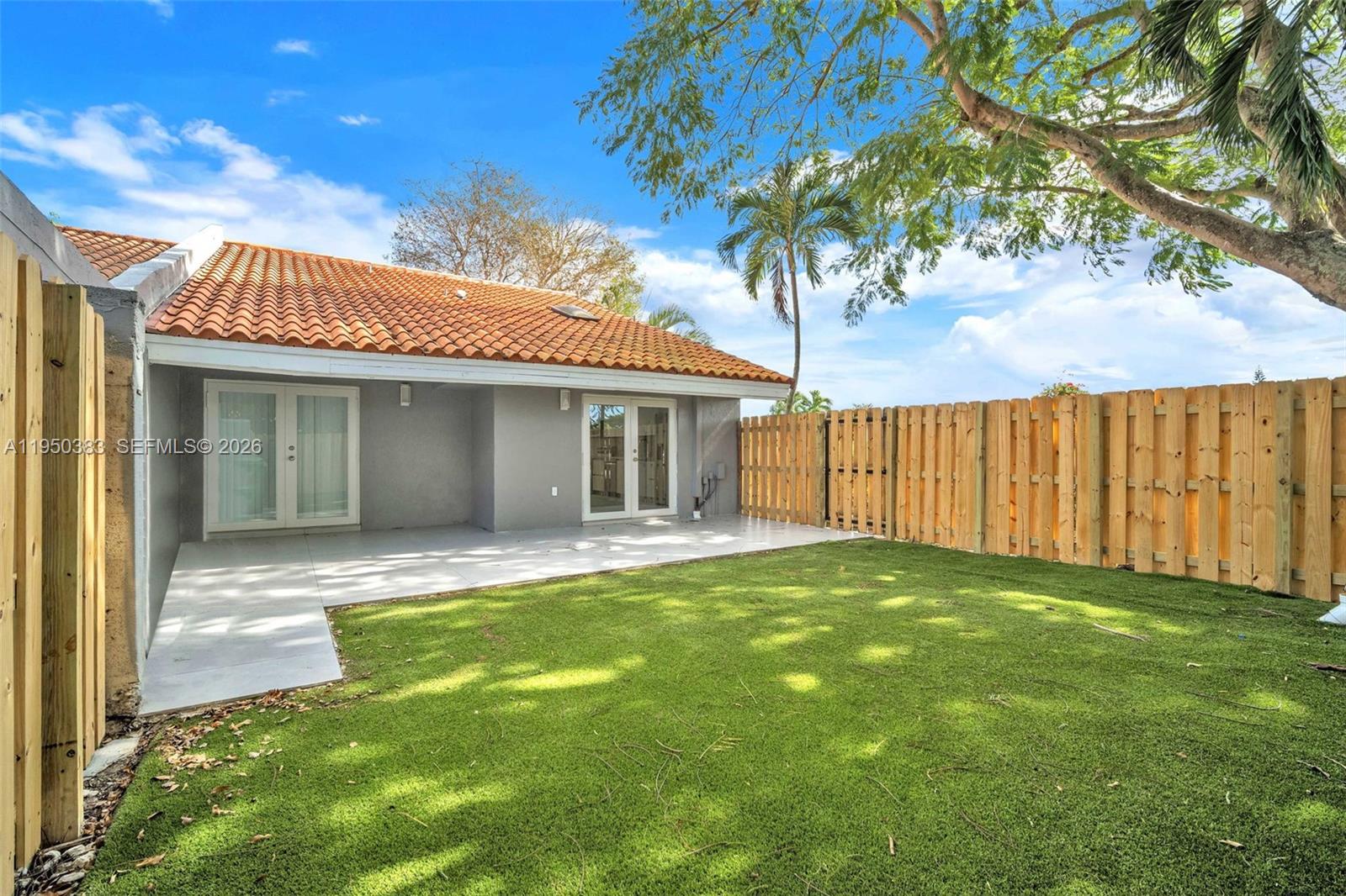 8394 Southwest 148th Avenue, Unit 8394 Miami, FL 33193 - Photo 11 of 15 a view of a house with a backyard