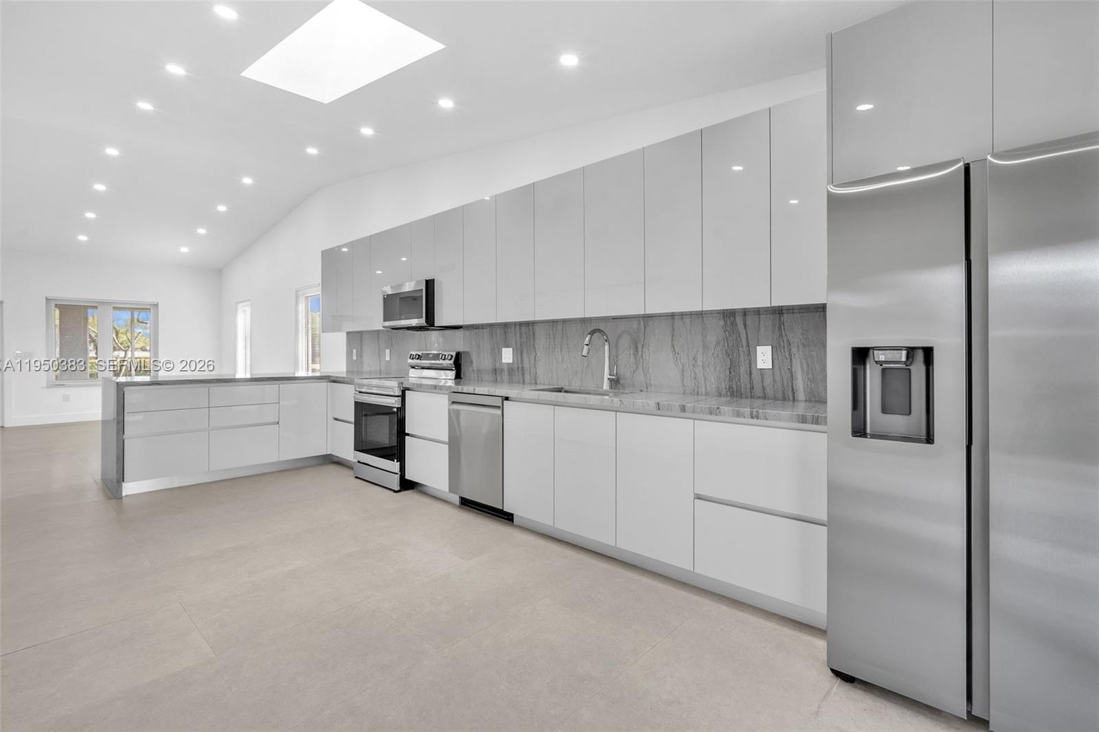 8394 Southwest 148th Avenue, Unit 8394 Miami, FL 33193 - Photo 4 of 15 a kitchen with white cabinets and white stainless steel appliances