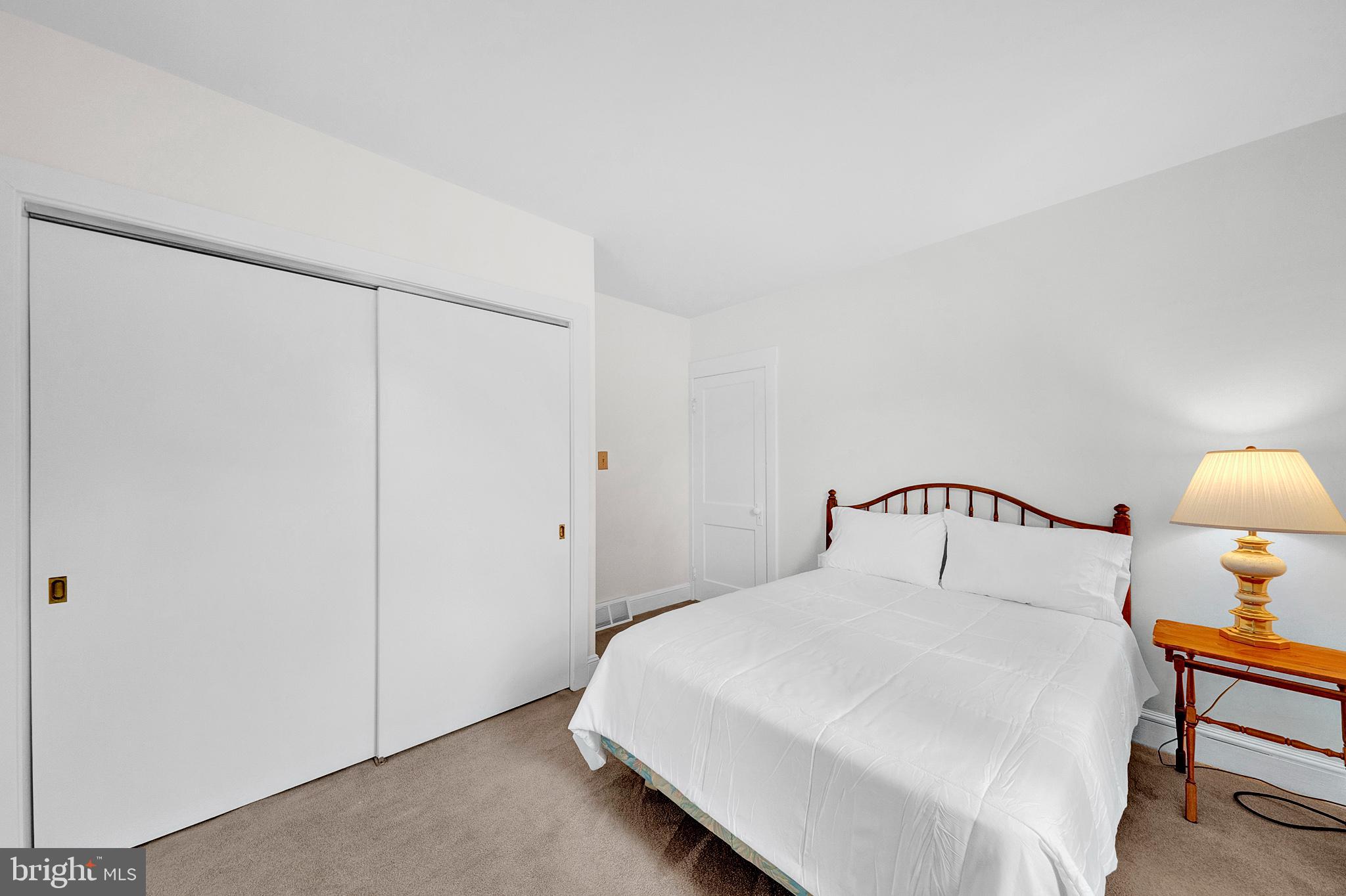 7 Diverty Road Pennington, NJ 08534 - Photo 20 of 45 a bedroom with a bed and a lamp on dresser