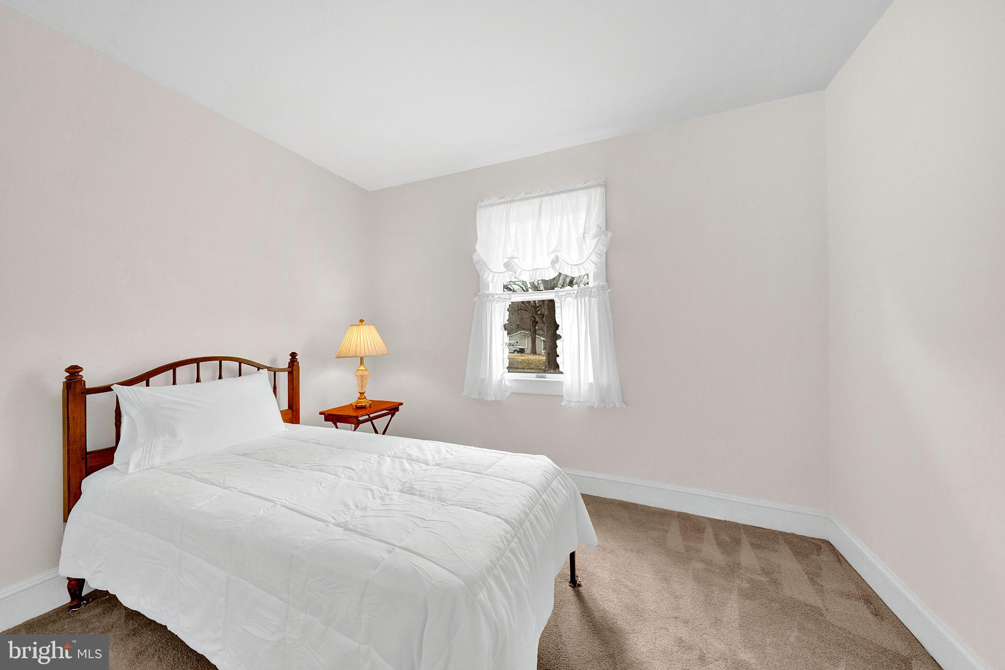7 Diverty Road Pennington, NJ 08534 - Photo 21 of 45 a bedroom with a bed and a lamp