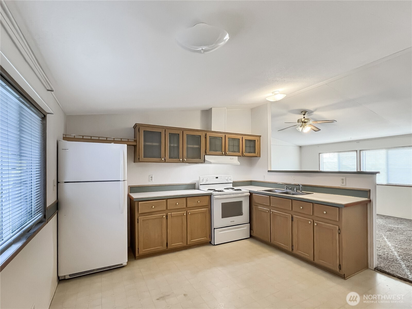 10900 Kuhlman Road Southeast, Unit 54 Olympia, WA 98513 - Photo 4 of 15 a kitchen with a sink and white cabinets