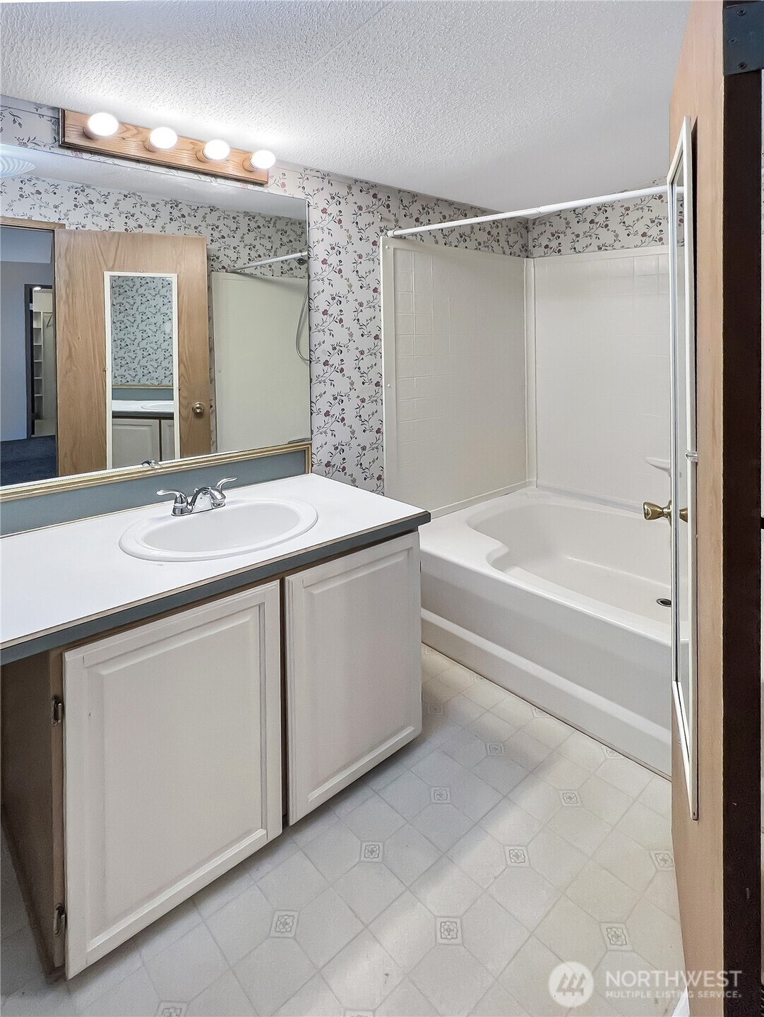 10900 Kuhlman Road Southeast, Unit 54 Olympia, WA 98513 - Photo 9 of 15 a bathroom with a sink vanity tub and a mirror