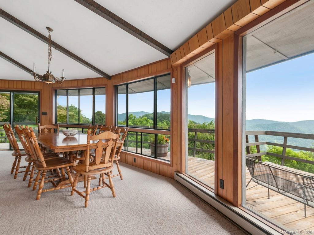 1263 Up Over Road Canton, NC 28716 - Photo 11 of 48 a dining room with furniture large windows and wooden floor