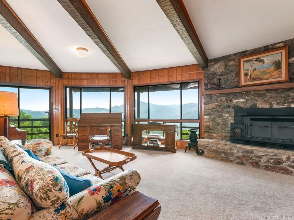 1263 Up Over Road Canton, NC 28716 - Photo 23 of 48 a living room with furniture a fireplace and floor to ceiling windows