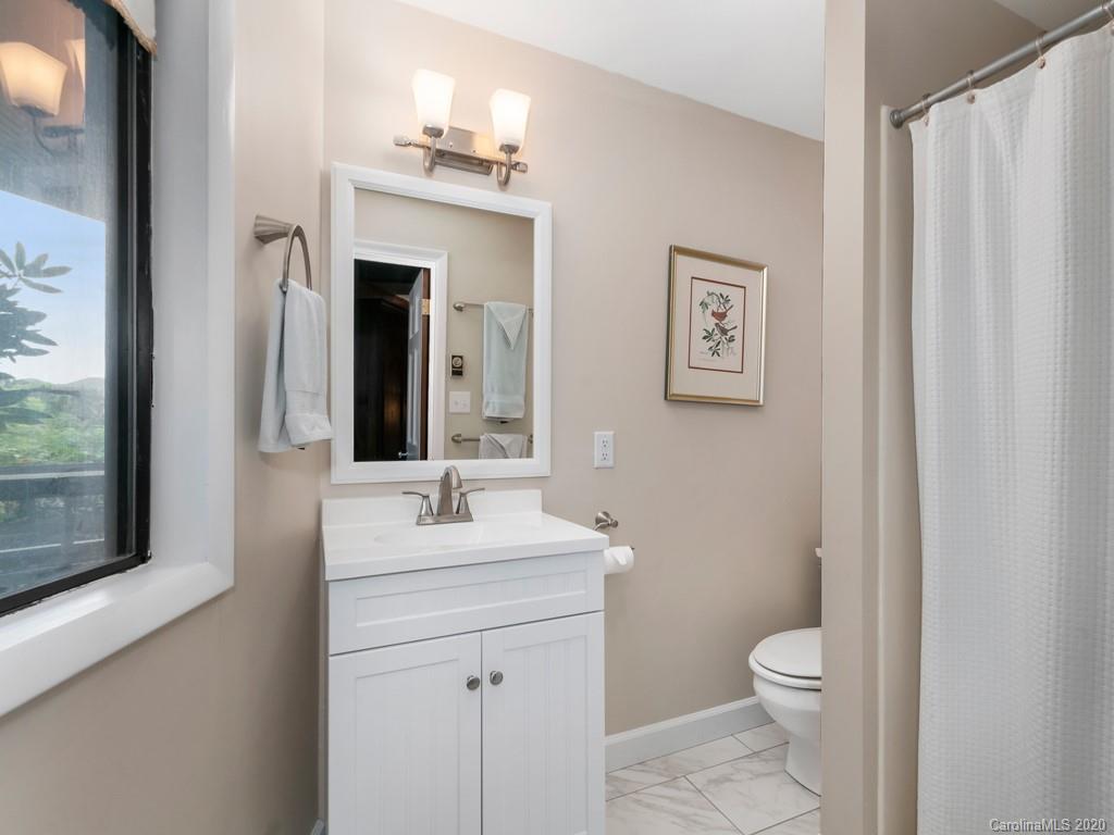 1263 Up Over Road Canton, NC 28716 - Photo 29 of 48 a bathroom with a toilet a sink and a mirror