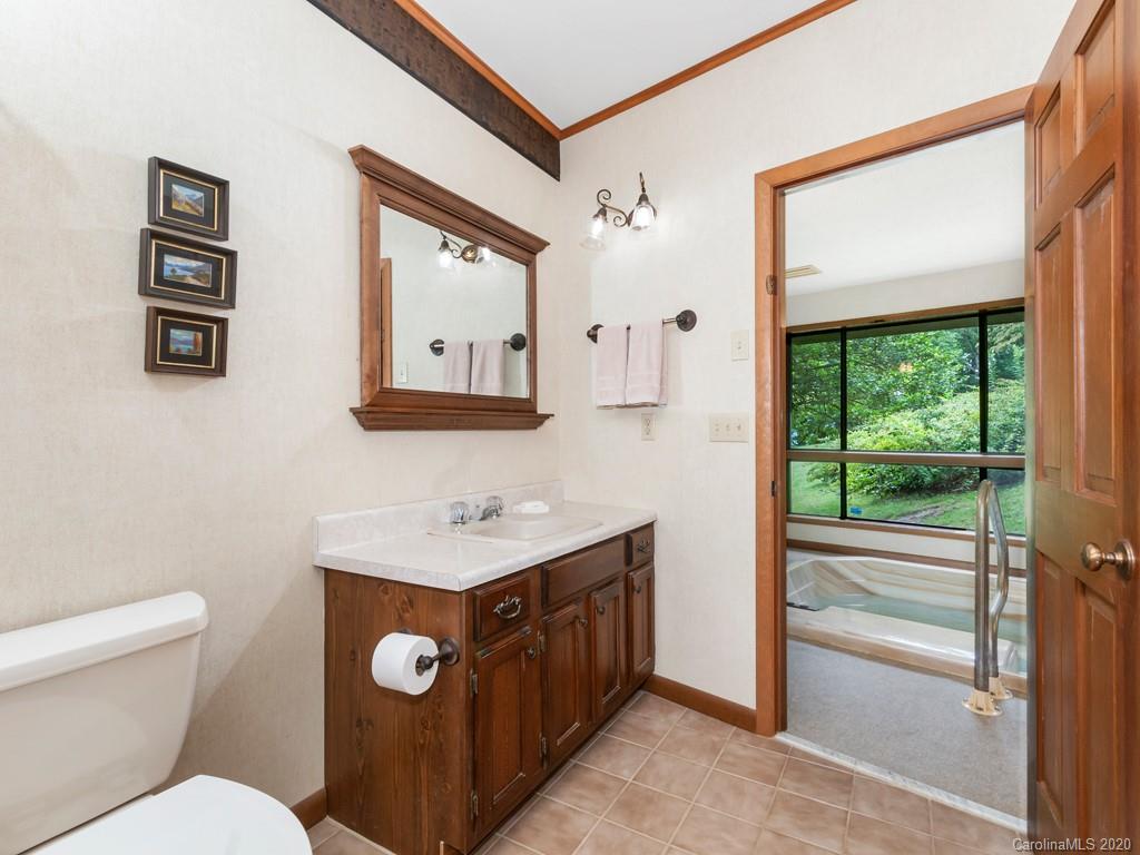 1263 Up Over Road Canton, NC 28716 - Photo 32 of 48 a bathroom with a toilet a sink and a mirror