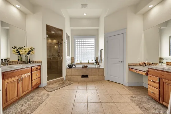a spacious bathroom with a granite countertop tub sink and mirror